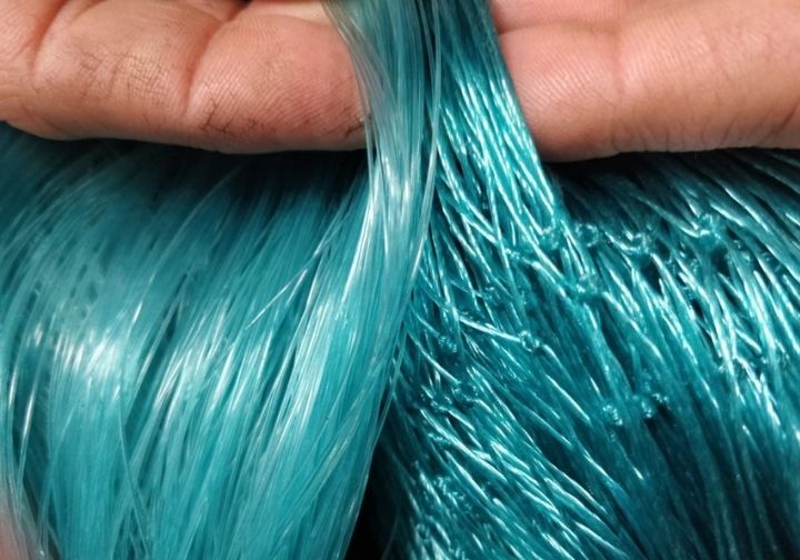 A person holding a blue monofilament fishing line.